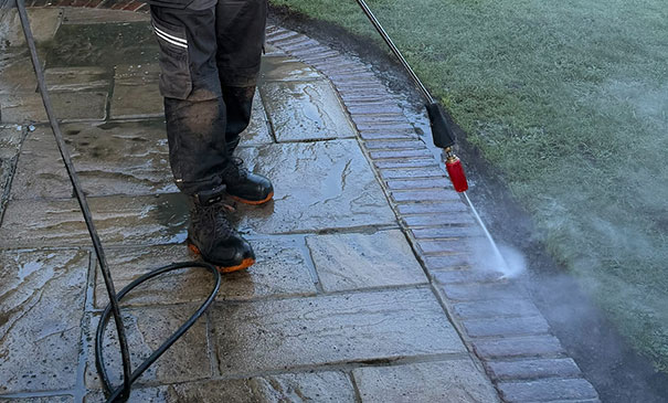 Driveway pressure washing in Pirbright removing moss dirt and algae