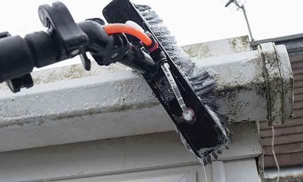 Gutter cleaning service in Wood Street Village Guildford clearing leaves and debris